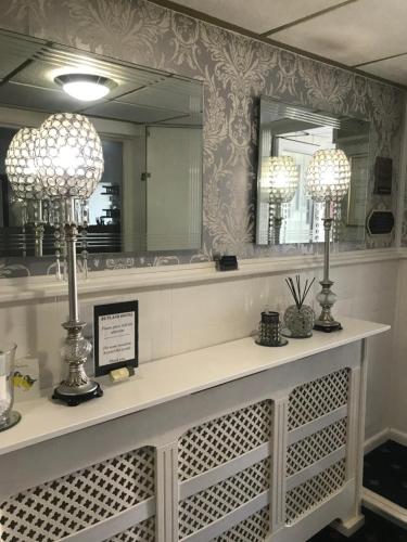 a vanity with two lamps and a mirror at The Rutland in Blackpool