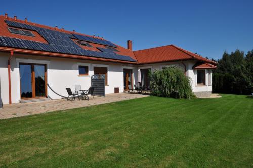 a house with solar panels on the roof at Apartamenty Sowiogórskie in Pieszyce