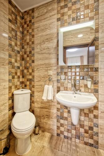 a bathroom with a toilet and a sink at Къща за гости Relax in Hisarya