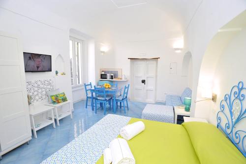 een woonkamer met een groene bank en een tafel bij CASETTAZZURRA in Amalfi