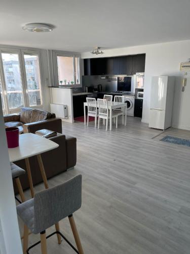 a living room and kitchen with a couch and a table at KP Home in Chilly-Mazarin