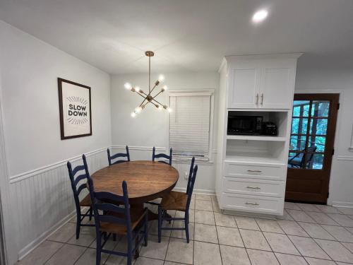 a kitchen and dining room with a table and chairs at Modern Athens Home 4bd, 3bth in Athens