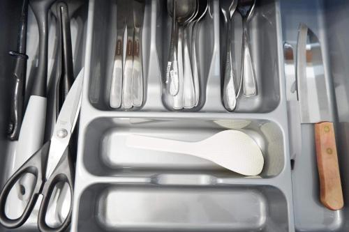 a drawer full of kitchen utensils with a sink at Azure Urban Beach Resort by Melrose Avenue in Manila