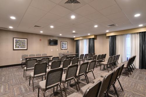 a conference room with rows of chairs and a podium at Hampton Inn & Suites Chippewa Falls in Chippewa Falls