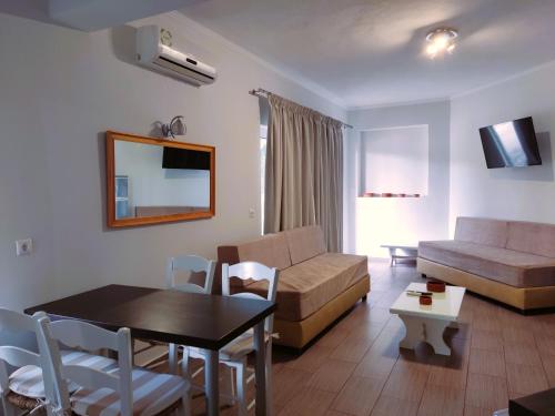 a living room with a couch and a table at Tarmaros - Families & Groups in Sissi