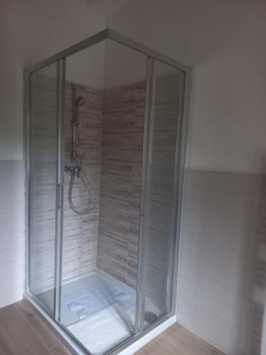 una ducha con mampara de cristal en un baño en IL VECCHIO CAMINO, en Baraggia di Boca