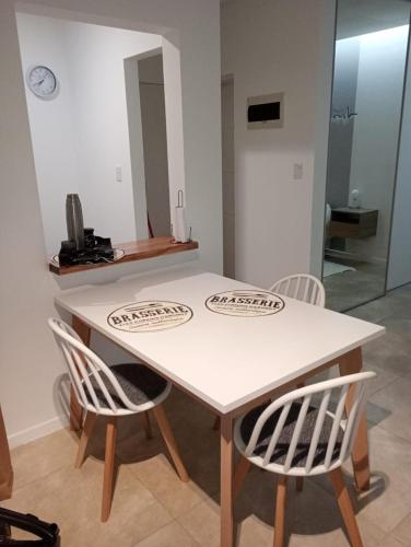 a white table and two chairs in a room at Paisaje 1 in Comodoro Rivadavia