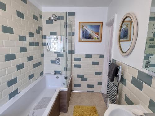 a bathroom with a tub and a shower at Tiffy's Place in Blackpool