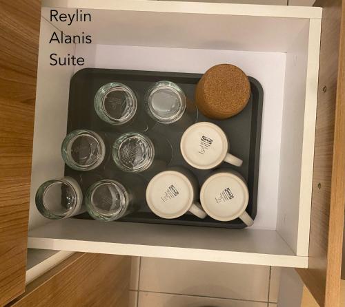 a drawer filled with glass jars and cork at Reylin Alanis Suite // Free Wifi & Netflix // Airport Shuttle Service in Sepang