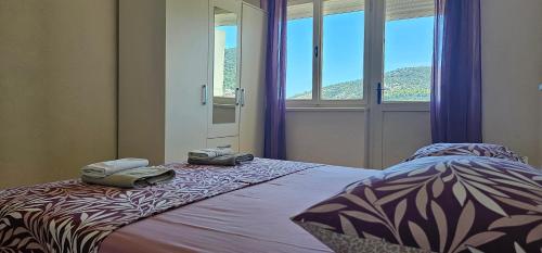 a bedroom with a bed with two towels on it at Coastal Charm: Apartmani Pazanin in Vinišće