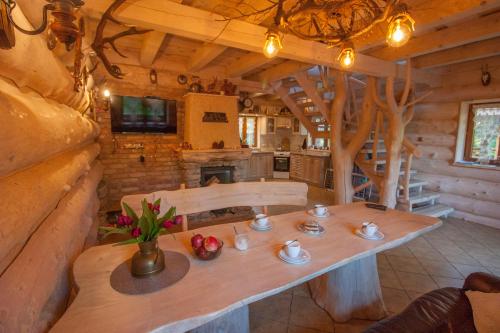 a wooden table in a room with a kitchen at Chatka Ustrzyki in Ustrzyki Dolne