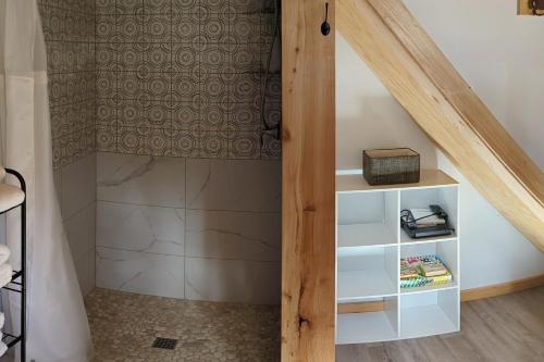 a room with a staircase with a book shelf at Whale Pass Adventure Property 
