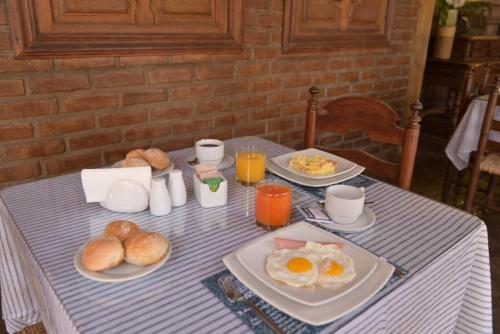 a table with plates of eggs and bread on it at Hotel & Hacienda El Carmelo in Ica