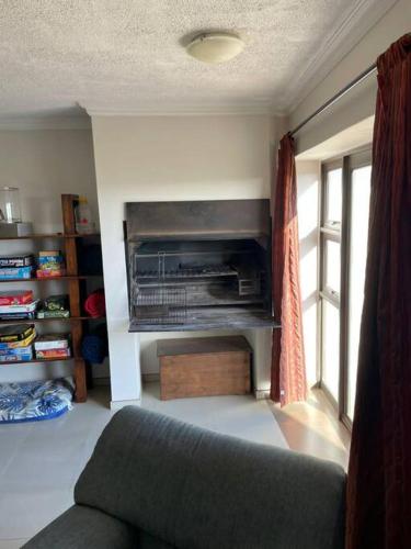 a living room with a couch and a window at Namibia Coastal Retreat in Walvis Bay