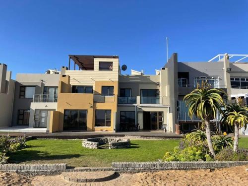 a large building with palm trees in front of it at Namibia Coastal Retreat in Walvis Bay
