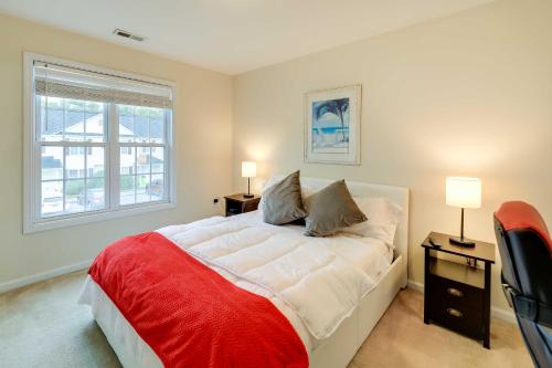 a bedroom with a large bed with two tables and two lamps at Havelock Townhome with Patio about 8 Miles to River in Havelock