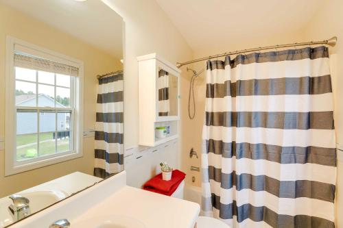 a bathroom with a sink and a shower curtain at Havelock Townhome with Patio about 8 Miles to River in Havelock