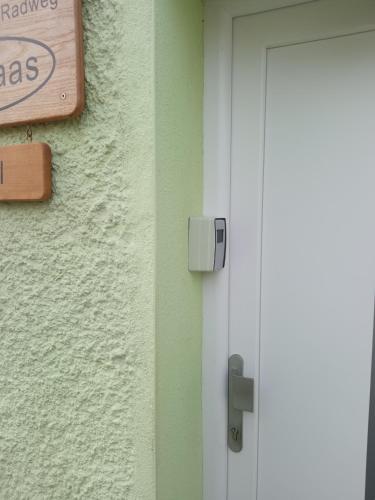 a door with a sign on the side of a building at Ferienwohnung am Kocher-Jagst Radweg in Neuenstadt am Kocher