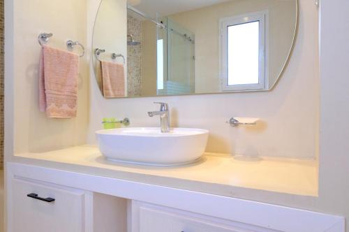 a bathroom with a white sink and a mirror at Dar Habiba in Hammamet
