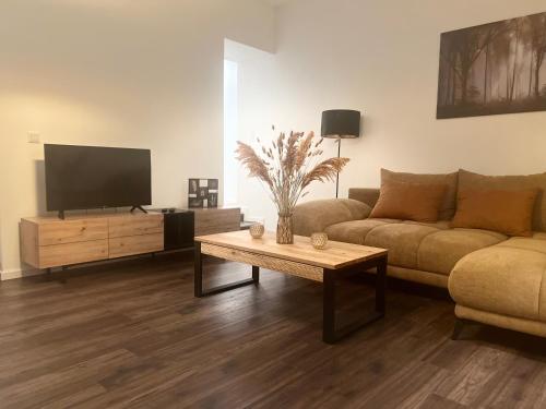 a living room with a couch and a coffee table at Golden Gate Orth an der Donau in Orth an der Donau