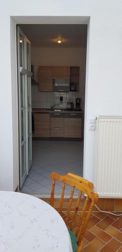 a view of a kitchen with a table and a bench at Villa Hoffnung in Bad Elster