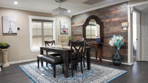 a dining room with a table and chairs and a mirror at Briarcliff Manor - 5 Minutes from DFW Airport in Irving
