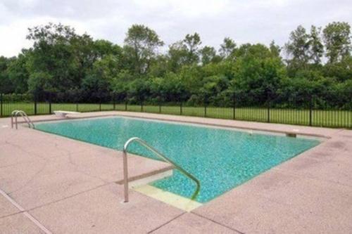 a large swimming pool with a metal hand rail in it at 2-Acre Highland Park Retreat with Heated Pool ~ 5* in Highland Park