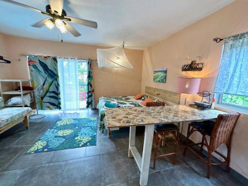 a living room with a table and a bed at Cabarete Boutique Kite Hotel for up to 15 people in Cabarete