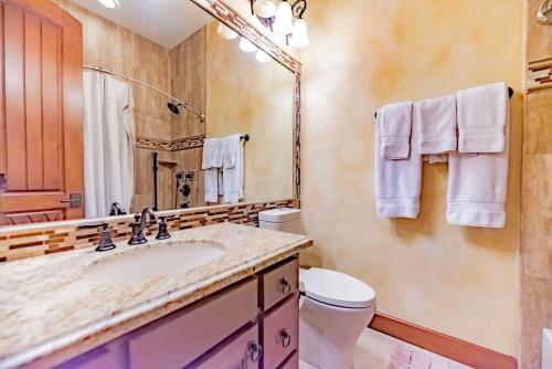 a bathroom with a sink and a toilet and a mirror at Casa Rayo de Sol - Private ranch guest home in Mission