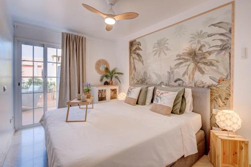 a bedroom with a large bed with a ceiling fan at Rooftop Del Mar in Palm-mar