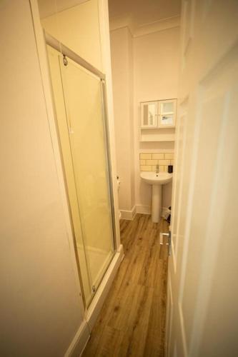 a bathroom with a shower and a sink at Spacious Sea-View Flat with Easy Invest in Lowestoft