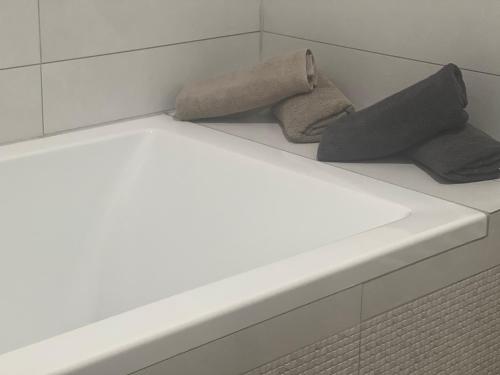 two towels sitting on a shelf in a bathroom at Golden Gate Orth an der Donau in Orth an der Donau