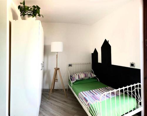 a bedroom with a bed with a black headboard at La casita in Civitavecchia