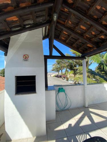 a building with a fire hydrant next to a beach at Pousada Aventura in Passo de Torres