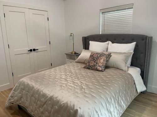 a bed with two pillows on it in a bedroom at Stylish, 2 Bedroom in Houston-Bellaire in Houston