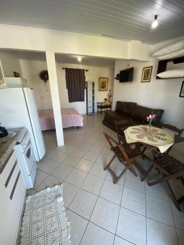 a living room with a couch and a table at Pousada Aventura in Passo de Torres