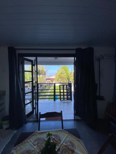 a room with a door open to a porch at Pousada Aventura in Passo de Torres