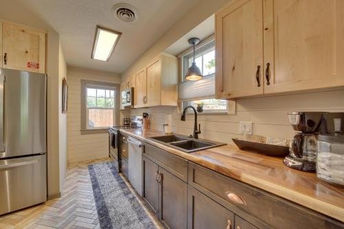 a kitchen with wooden cabinets and stainless steel appliances at Less Than 1 Mi to Dtwn Home with Deck in Clarkdale! in Clarkdale