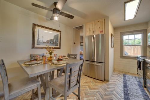 a kitchen with a table and a stainless steel refrigerator at Less Than 1 Mi to Dtwn Home with Deck in Clarkdale! in Clarkdale
