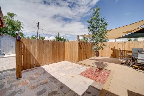 a backyard with a wooden fence and a tree at Less Than 1 Mi to Dtwn Home with Deck in Clarkdale! in Clarkdale