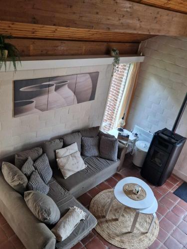 a living room with a couch and a table at Bulle ivoire in Hastière-par-delà