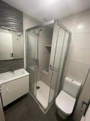 a bathroom with a shower and a toilet and a sink at Casa Bia Plus in Elche
