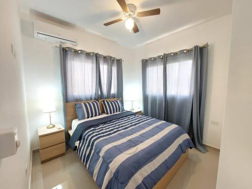 um quarto com uma cama e uma ventoinha de tecto em Chelsie 3 vista piscina em Bayahibe