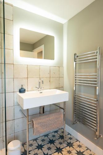 a bathroom with a sink and a mirror at Tryfan - Snowdonia, North Wales in Bethesda
