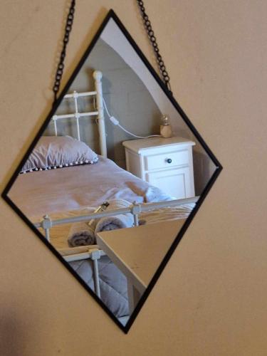 a mirror reflection of a bedroom with a bed at Bulle ivoire in Hastière-par-delà