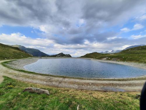 a small lake in the middle of a field at Ferienwohnung Hilber in Schmirn