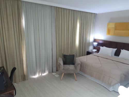 Una cama o camas en una habitación de Flat Super Luxo Verbo Divino