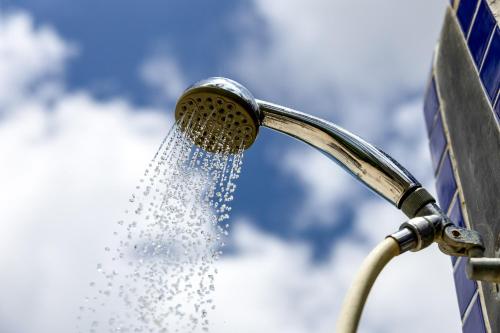 a shower head with water coming out of it at Oceanfront - Villa Port of Call - in Kralendijk