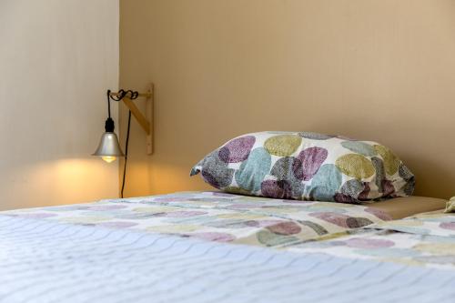 a bed with a pillow sitting on top of it at Oceanfront - Villa Port of Call - in Kralendijk