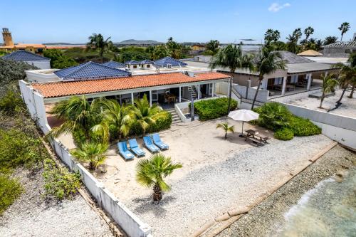 an aerial view of a house with a beach at Oceanfront - Villa Port of Call - in Kralendijk
